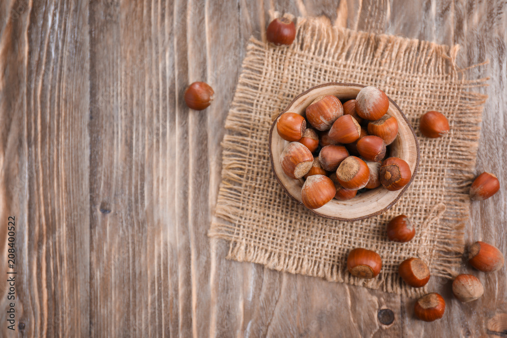 Bowl with hazelnuts on wooden table Bowl with hazelnuts on wooden table