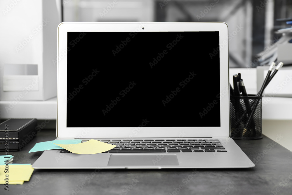 Stylish workplace with laptop on table Stylish workplace with laptop on table