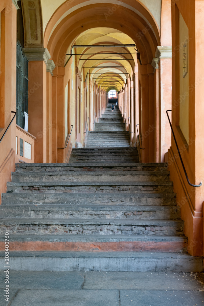 Stairs leading up to San Luca in Bologna, Italy traveling under over 600 arches with a shallow depth of field