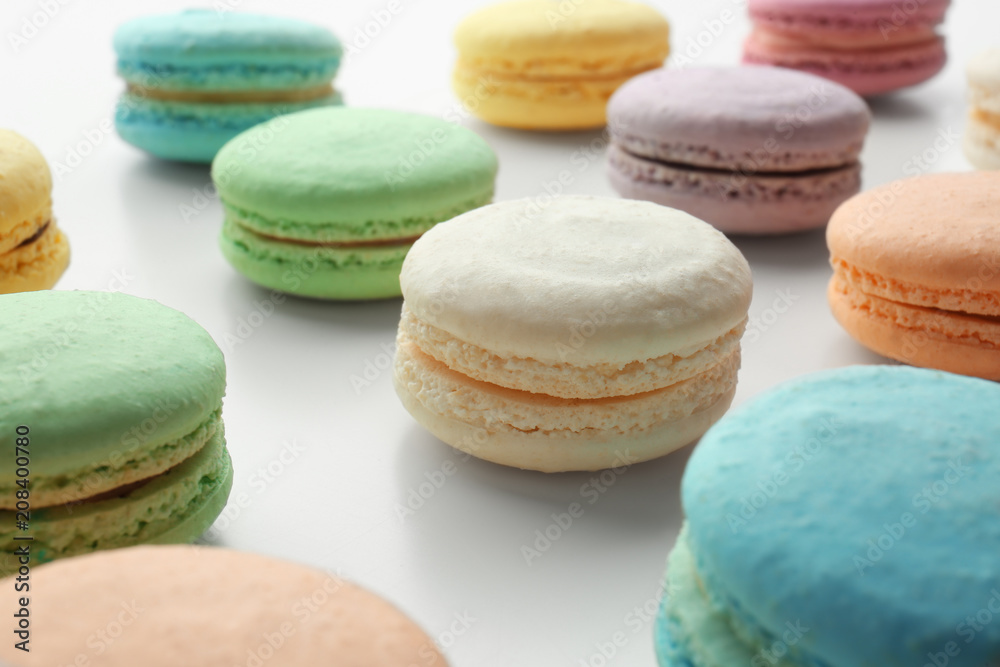 Tasty colorful macarons on white background, closeup Tasty colorful macarons on white background, closeup