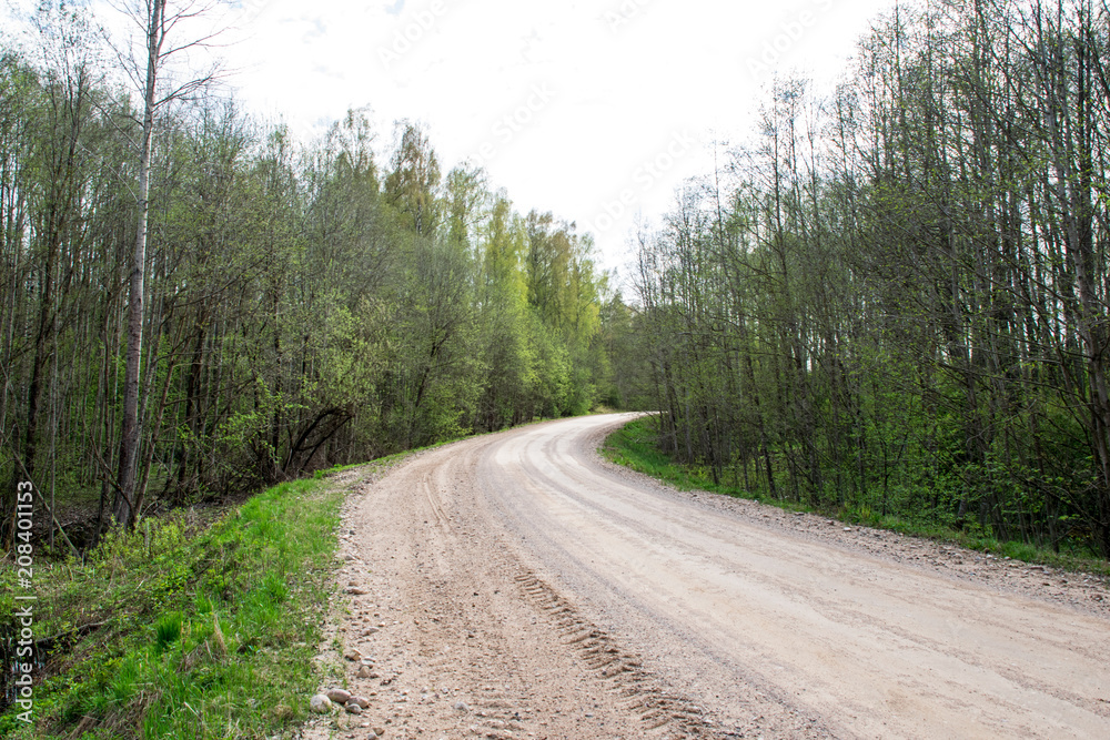 empty gravel road in the countryside in summer heat