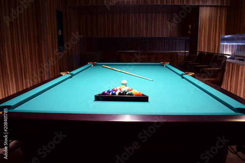 Colored balls of the American pool are collected in a triangle on a billiard table