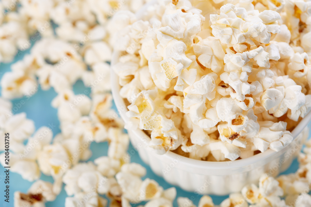 Popcorn on a bright blue background. Film. Fast food. Corn Popcorn on a bright blue background. Film. Fast food. Corn