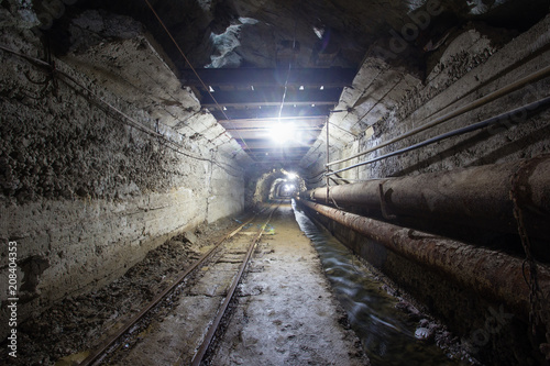 Underground old ore gold mine tunnel shaft passage mining technology with rails © Mishainik