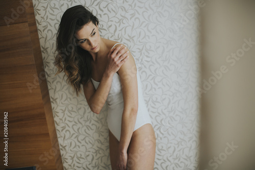 Slim young woman poses in h...