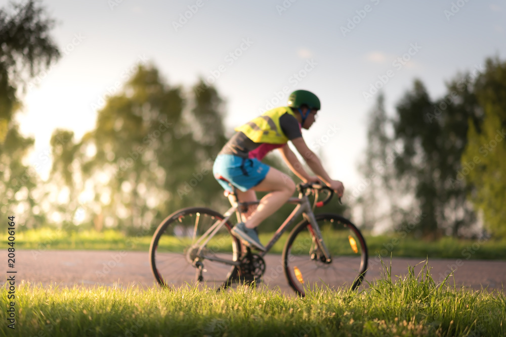 Cyclist man riding road sport bike in sunny day on a mountain road Cyclist man riding road sport bike in sunny day on a mountain road