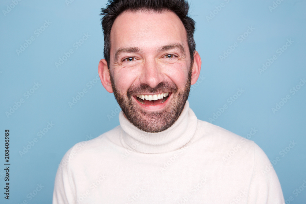 Fototapeta premium Close up older man with beard laughing against blue background