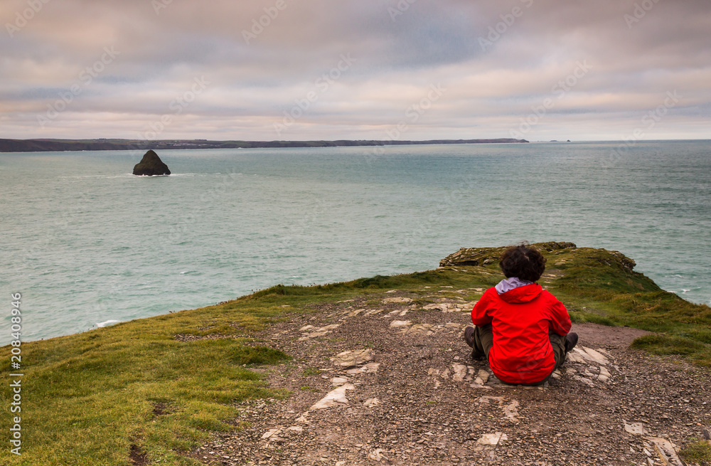 Sitting on the Cornish cliffs