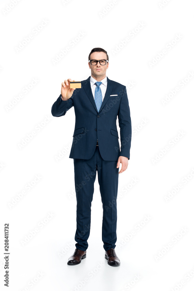 full length view of serious businessman in suit and eyeglasses holding credit card and looking at camera isolated on white full length view of serious businessman in suit and eyeglasses holding credit card and looking at camera isolated on white