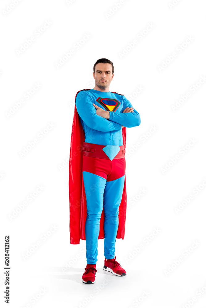 full length view of confident handsome superman standing with crossed arms  and looking at camera isolated on white Stock Photo | Adobe Stock