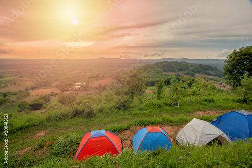 colorful tourist Glamping tents on mountain with nice scene of sunset