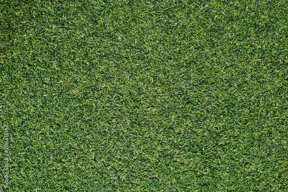 Obraz premium Artificial grass from football field Use as a beautiful green background.