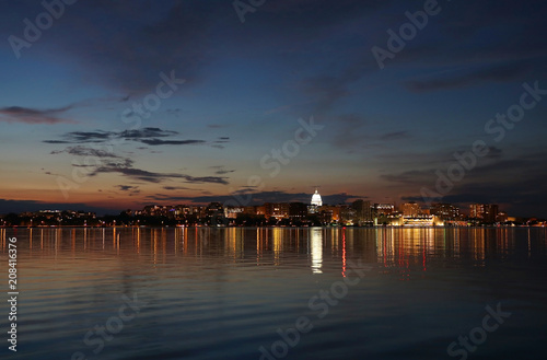 Downtown skyline of Madison, the capital city of Wisconsin, USA. After sunset view with State Capitol building dome against colorful sky reflected in lake Monona. photo
