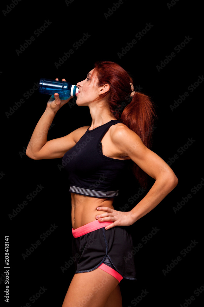 beautiful woman with bottle of water. Perfect female body isolated on black background beautiful woman with bottle of water. Perfect female body isolated on black background
