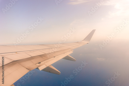 view from the airplane window, ocean blue, sunny day. Vacation concept