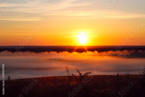 Misty dawn in the field photo