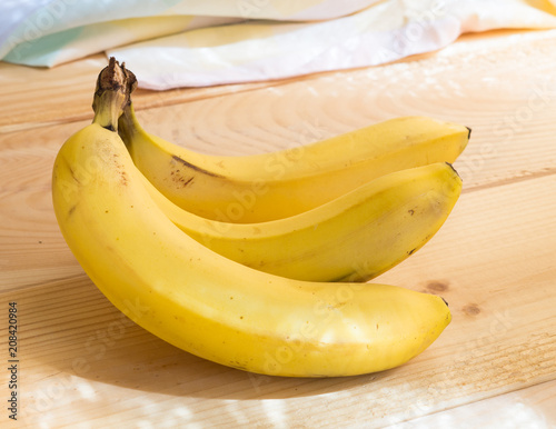 yellow ripe bananas on a wooden table