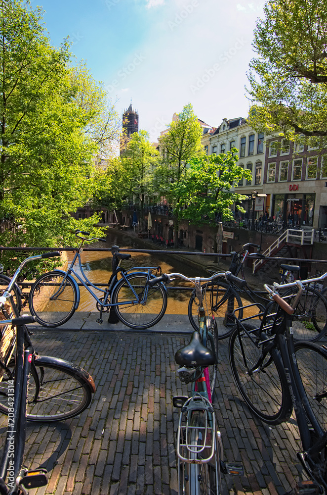 Utrecht, Netherlands- 02 MAY, 2018: Old city canal in Utrecht. Bikes on the bridge. A picturesque city for visiting tourists during their vacations