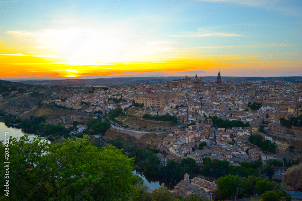Sunset at lookout of Toledo, Spain. Tajo river around the city and Alcazar and Cathedral at background. 