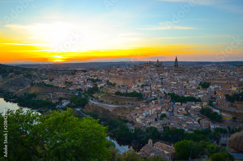 Sunset at lookout of Toledo, Spain. Tajo river around the city and Alcazar and Cathedral at background. 