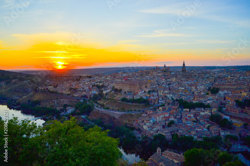 Sunset at lookout of Toledo, Spain. Tajo river around the city and Alcazar and Cathedral at background.