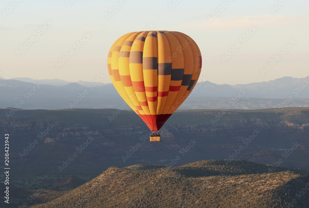 Fototapeta premium A Hot Air Balloon Soars Near Sedona, Arizona