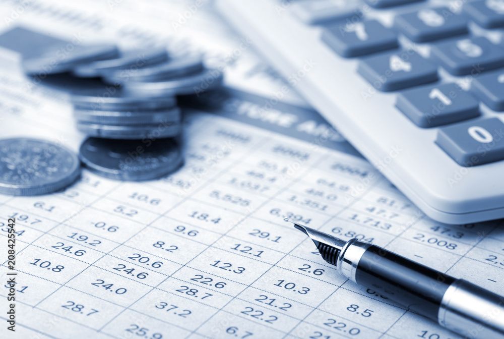 calculator, coins and pen on financial report calculator, coins and pen on financial report