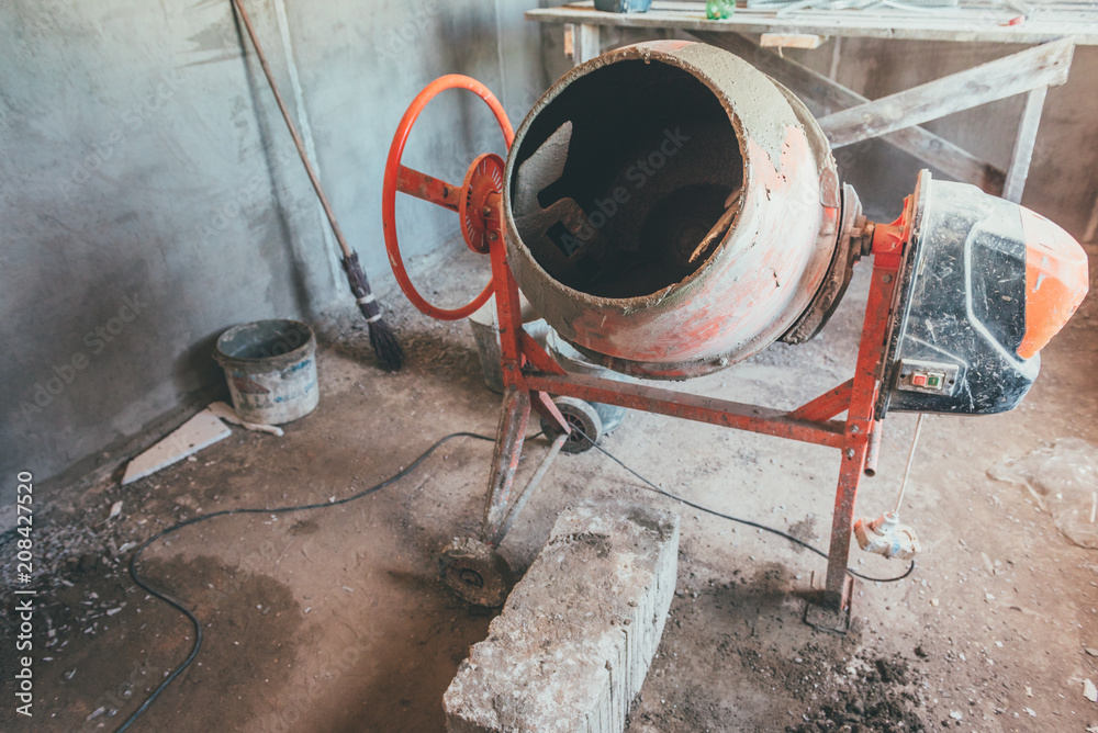 Cement concrete mixer at a construction site. Cement concrete mixer at a construction site.