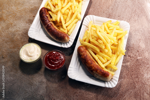Grilled sausage served with french fries or fried potatoes with sausage