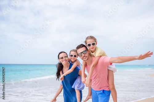 Happy beautiful family on the beach © travnikovstudio