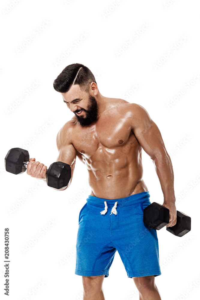 muscular man doing exercises with dumbbells. muscular man doing exercises with dumbbells.