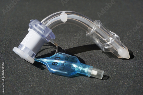tracheostomy tube on a black background