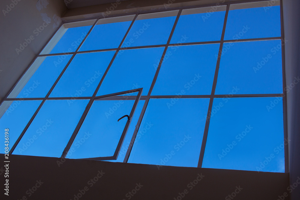 Blue sky view through upper transparent window with open leaf Blue sky view through upper transparent window with open leaf