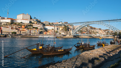 View of Douro river, Dom Luis I bridge from embankment of Vila Nova de Gaia, Porto, Portugal.
