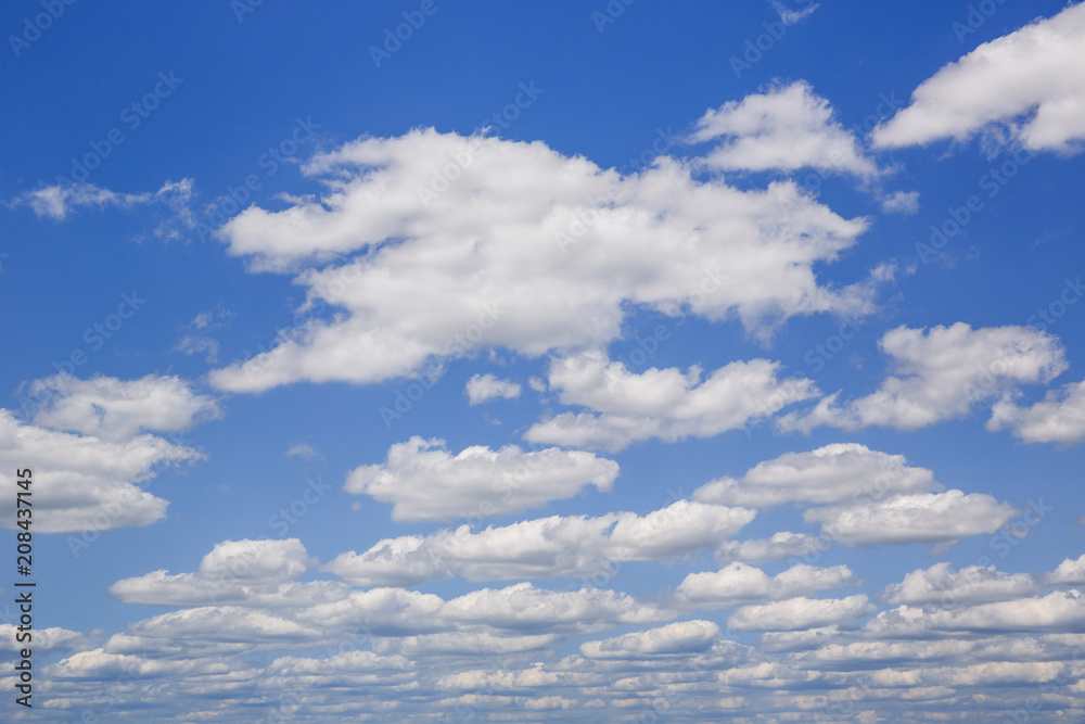 Blue sky with white puffy clouds. Clouds in the blue sky. Blue sky with white puffy clouds. Clouds in the blue sky.
