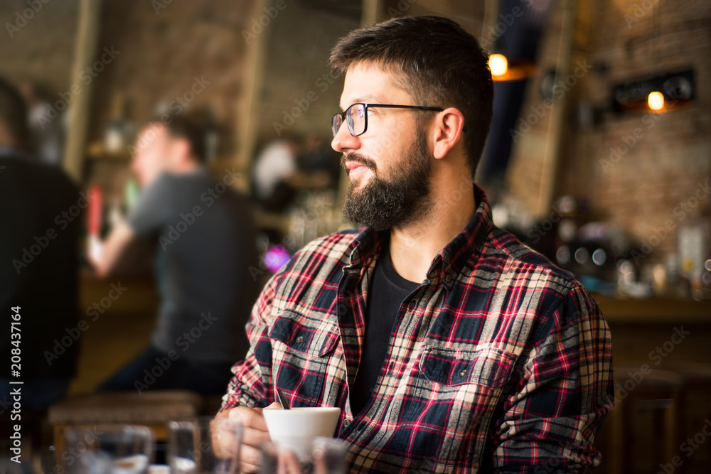 Bearded man in a coffee bar