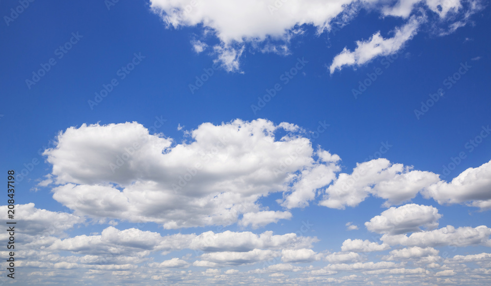 Fototapeta premium Blue sky with white puffy clouds. Clouds in the blue sky.