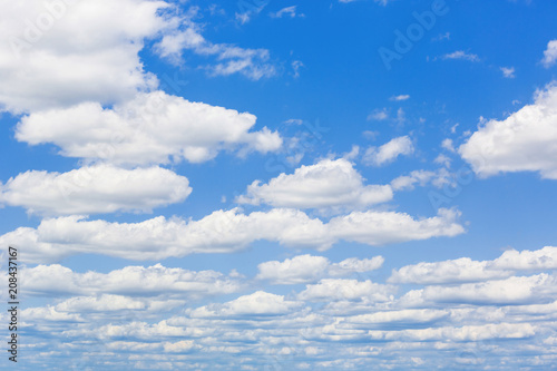 Blue sky with white puffy clouds. Clouds in the blue sky.