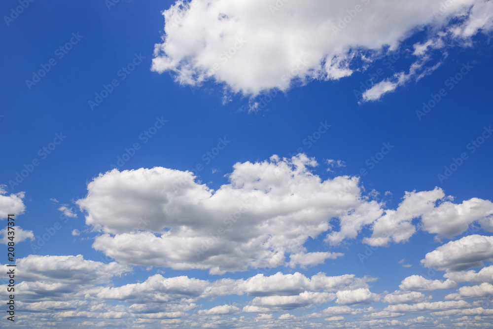 Blue sky with white puffy clouds. Clouds in the blue sky. Blue sky with white puffy clouds. Clouds in the blue sky.