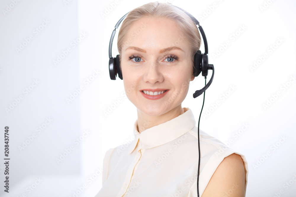Bright call center office. Two blonde women in a headset Bright call center office. Two blonde women in a headset