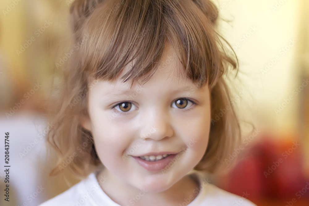 portrait of a beautiful little girl, smiling and looking directly at the camera. Selective focus portrait of a beautiful little girl, smiling and looking directly at the camera. Selective focus