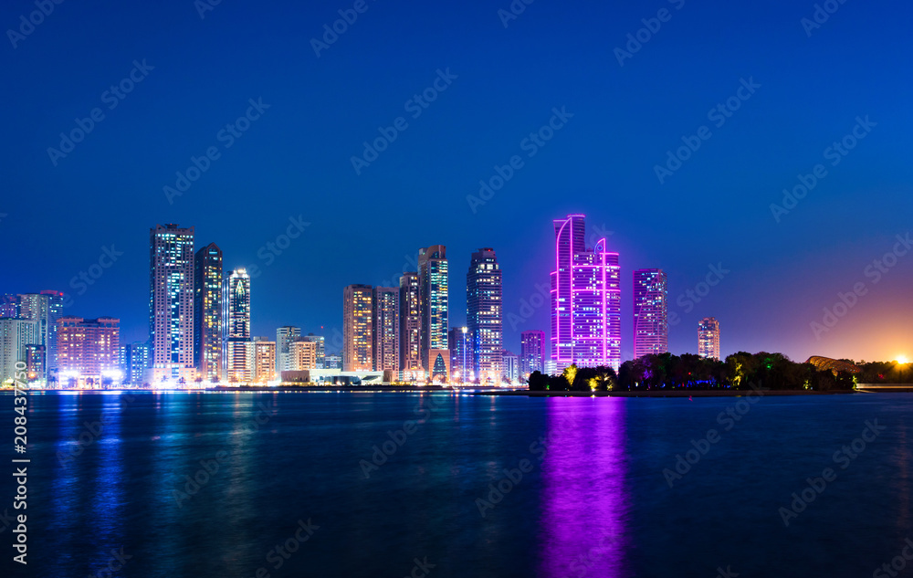 Sharjah waterfront cityscape in UAE at blue hour