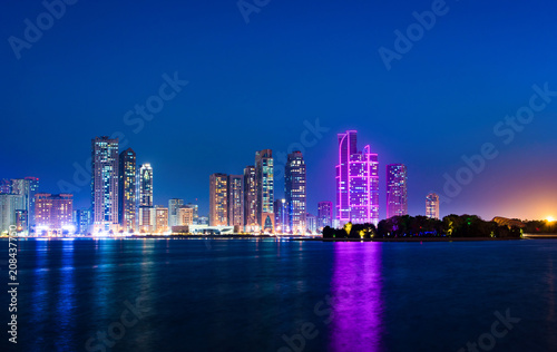 Sharjah waterfront cityscape in UAE at blue hour © creativefamily