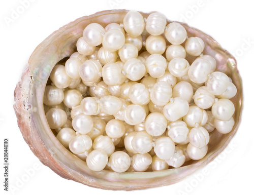Natural raw scallop with pearl beads on white background