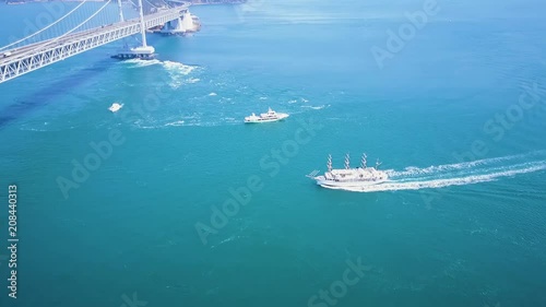 Naruto bridge, whirlpool viewing boats travel below ferrying tourists in Tokushima Japan. photo