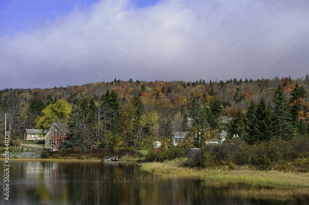 Lakeside living amidst fall foliage in New England.