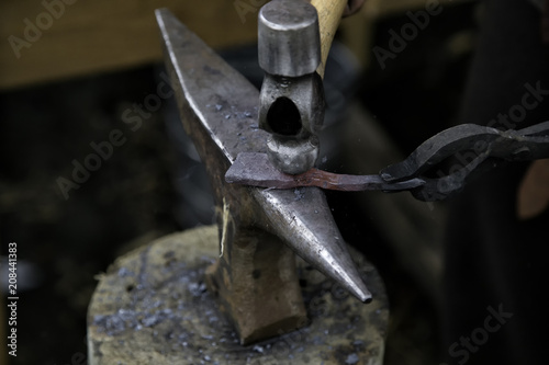 Fototapeta Naklejka Na Ścianę i Meble -  blacksmith striking hot iron