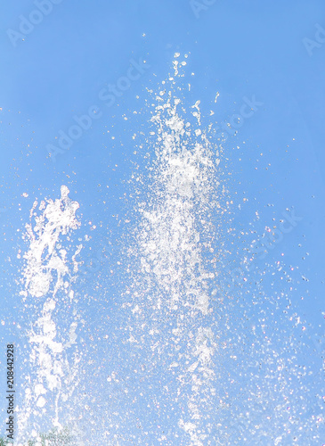 The fountain splashes against the sky