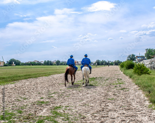 Riders in national clothes on horseback at the racetrack © kvdkz