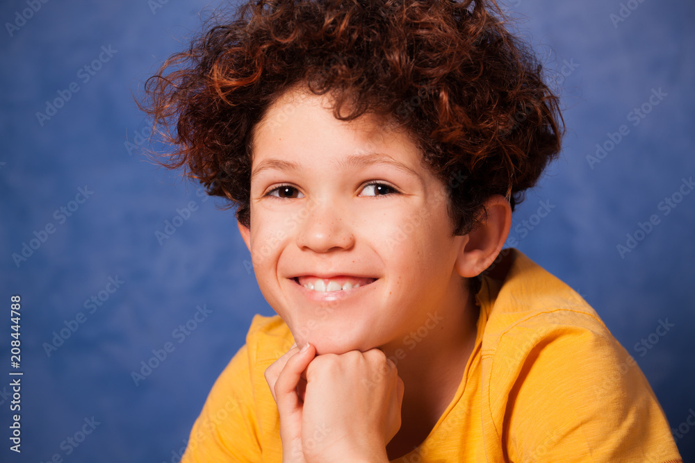 Portrait of happy young boy with curly hair Portrait of happy young boy with curly hair